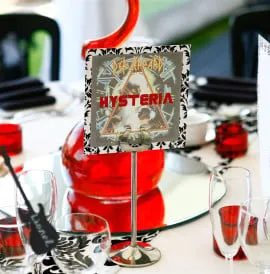 A decorative red, white and black wedding breakfast set up in this marquee.