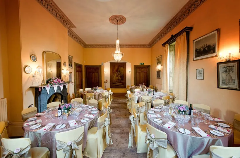 A wedding breakfast set up in the Regency Room with wonderful natural light coming through the bay windows