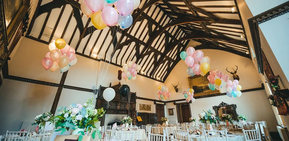 A wedding breakfast set up in the Great Hall with Disney’s ‘Up’ as a theme. This decadent room has great height for varied tall displays.